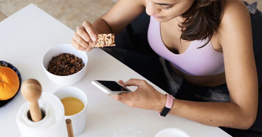 healthy lifestyle flatlay with protein bars, laptop, and coffee