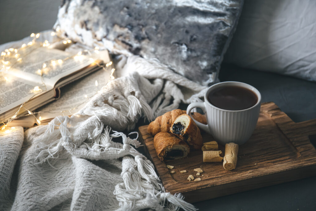 lifestyle image of woman enjoying Rockin Wellness hot chocolate in a festive living room