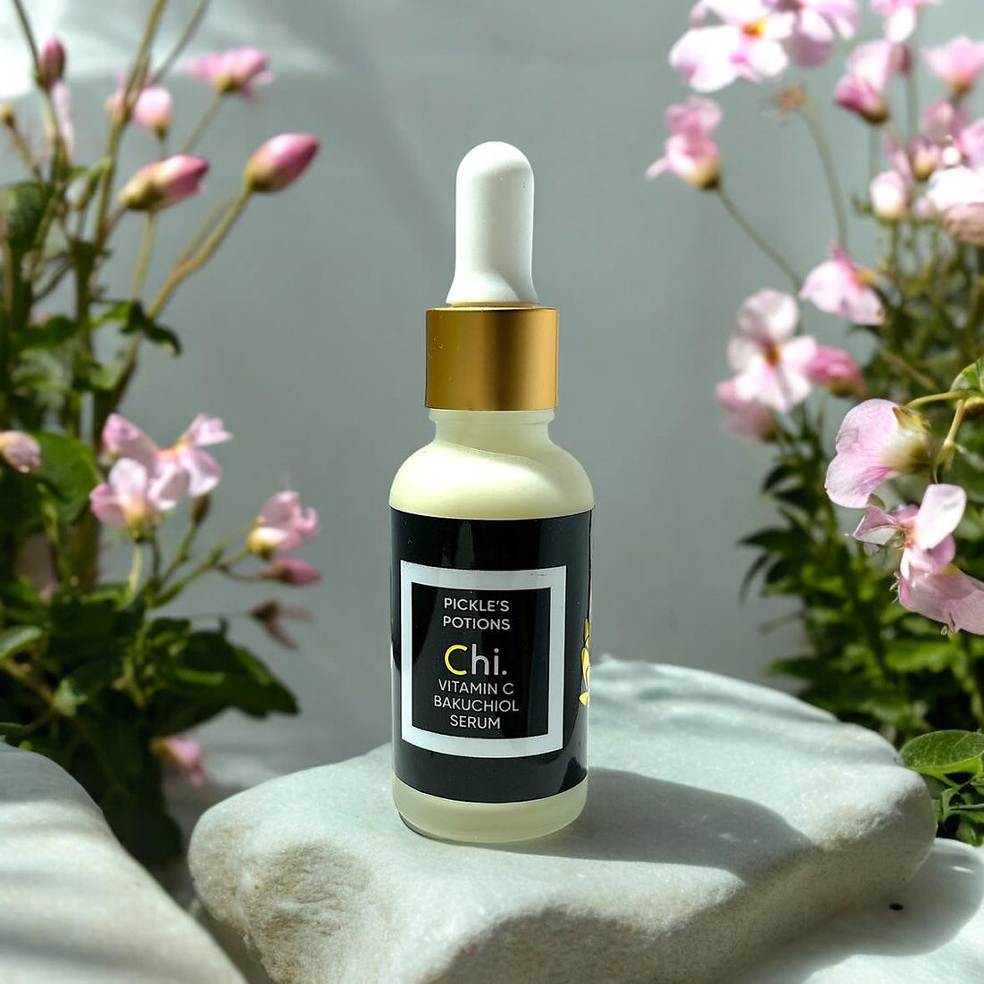 Pickle’s Potions Chi Serum Triple C + Bakuchiol product photo: elegant luxury skincare bottle styled for clean-beauty editorial, soft diffused lighting, neutral background, premium wellness aesthetic